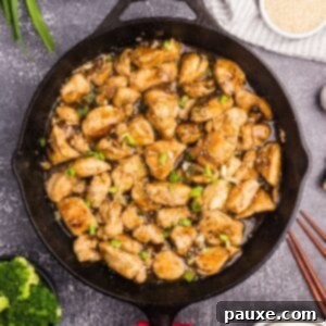 Sticky Honey Ginger Chicken 8 A skillet filled with perfectly cooked chicken stir fry coated in a glistening golden honey ginger sauce.