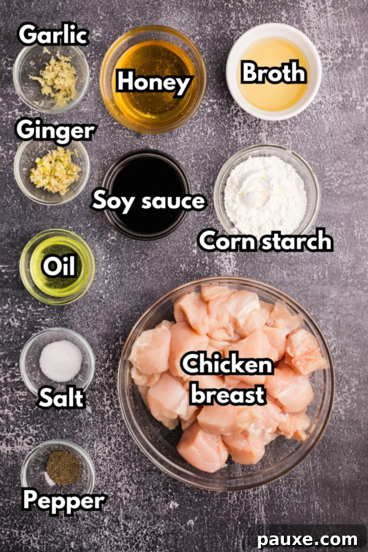 Sticky Honey Ginger Chicken 3 The array of fresh ingredients needed to make honey ginger chicken, including soy sauce, cornstarch, cubed chicken breast, and fresh ginger and garlic.