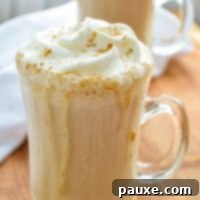 Homemade Instant Pot Pumpkin Spice Latte 8 A glass mug filled with a pumpkin spice latte and covered with whipped cream.