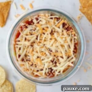 Power-Packed Greek Yogurt Dip 8 A bowl of dip with salsa, Greek yogurt, and topped with shredded cheese.