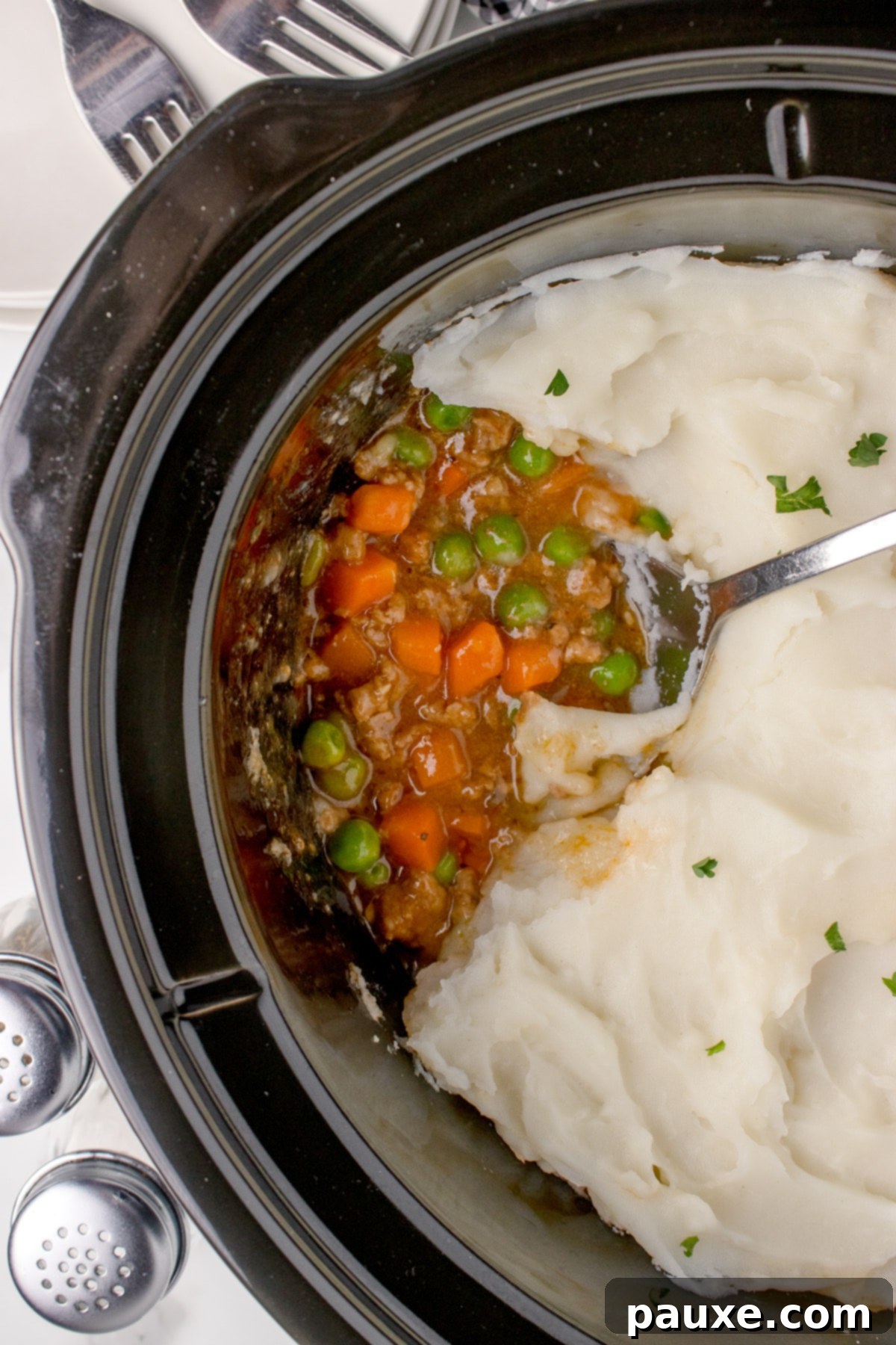 Set-It-And-Forget-It Shepherd's Pie 2 A slow cooker filled with cottage pie and topped with mashed potatoes.