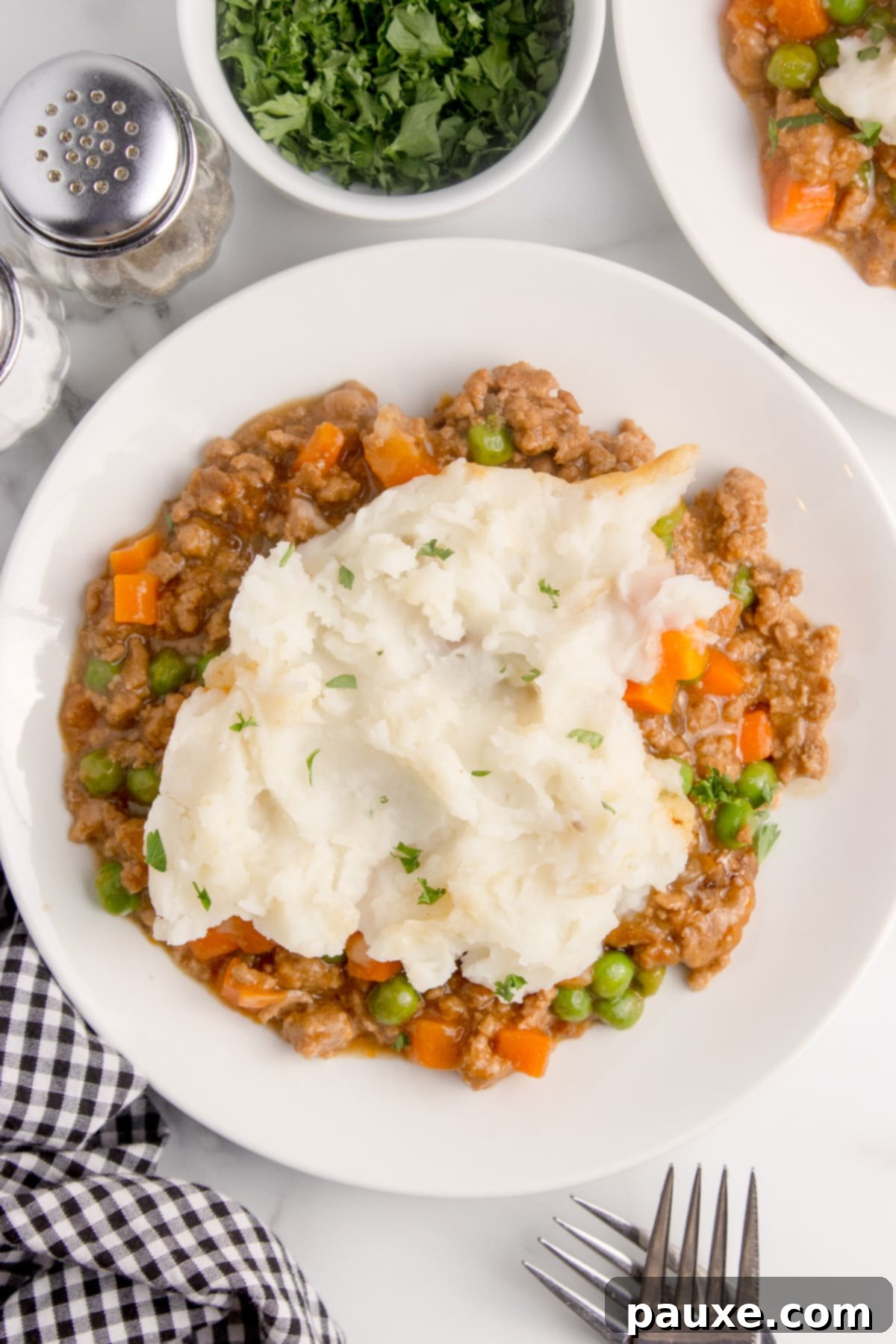 Set-It-And-Forget-It Shepherd's Pie 7 A plate filled with shepherd's pie and topped with mashed potatoes.