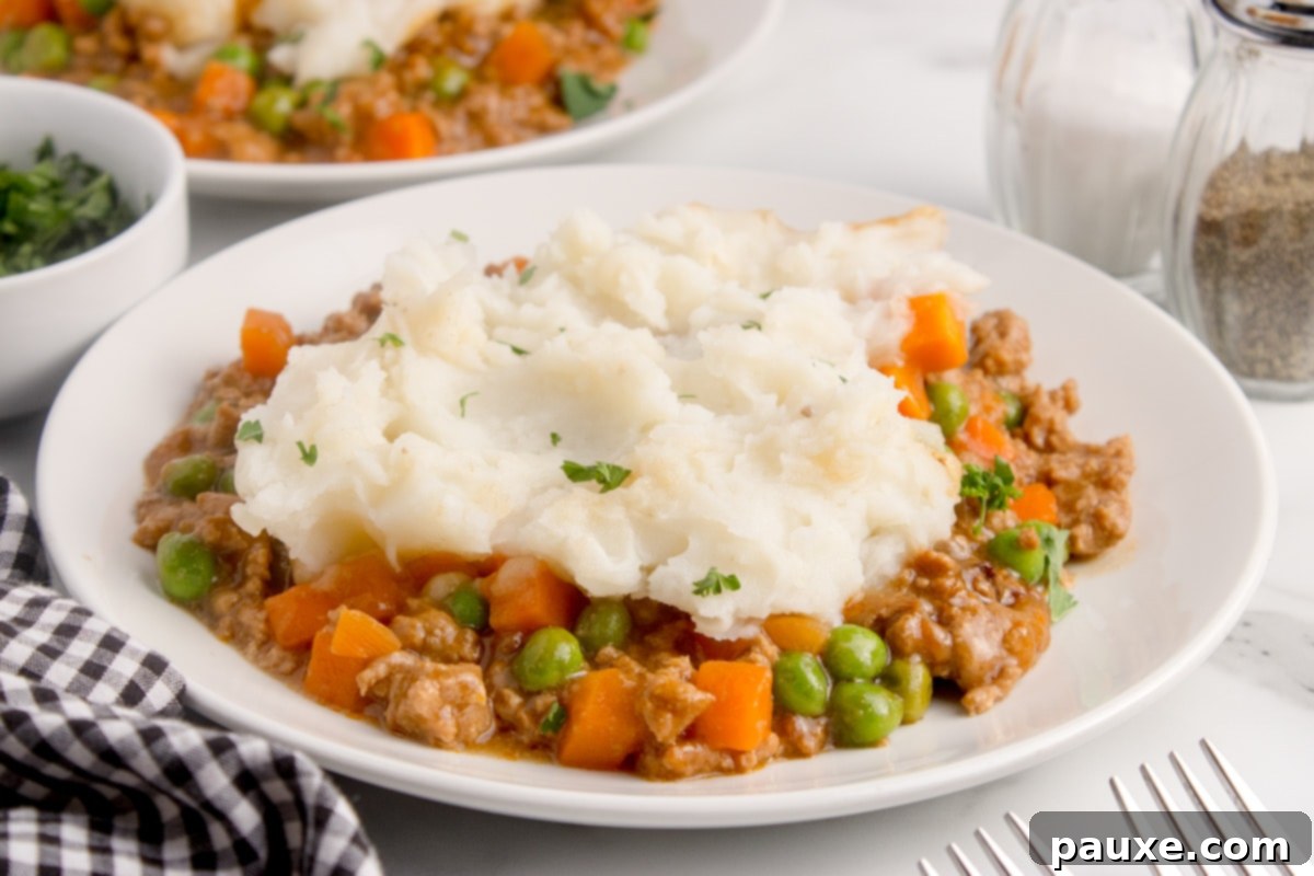 Set-It-And-Forget-It Shepherd's Pie 8 A plate of shepherd's pie topped with fluffy mashed potatoes.