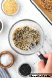The Ultimate Seed & Spice Blend 11 A small bowl of seeds and seasonings being mixed together with a small whisk.