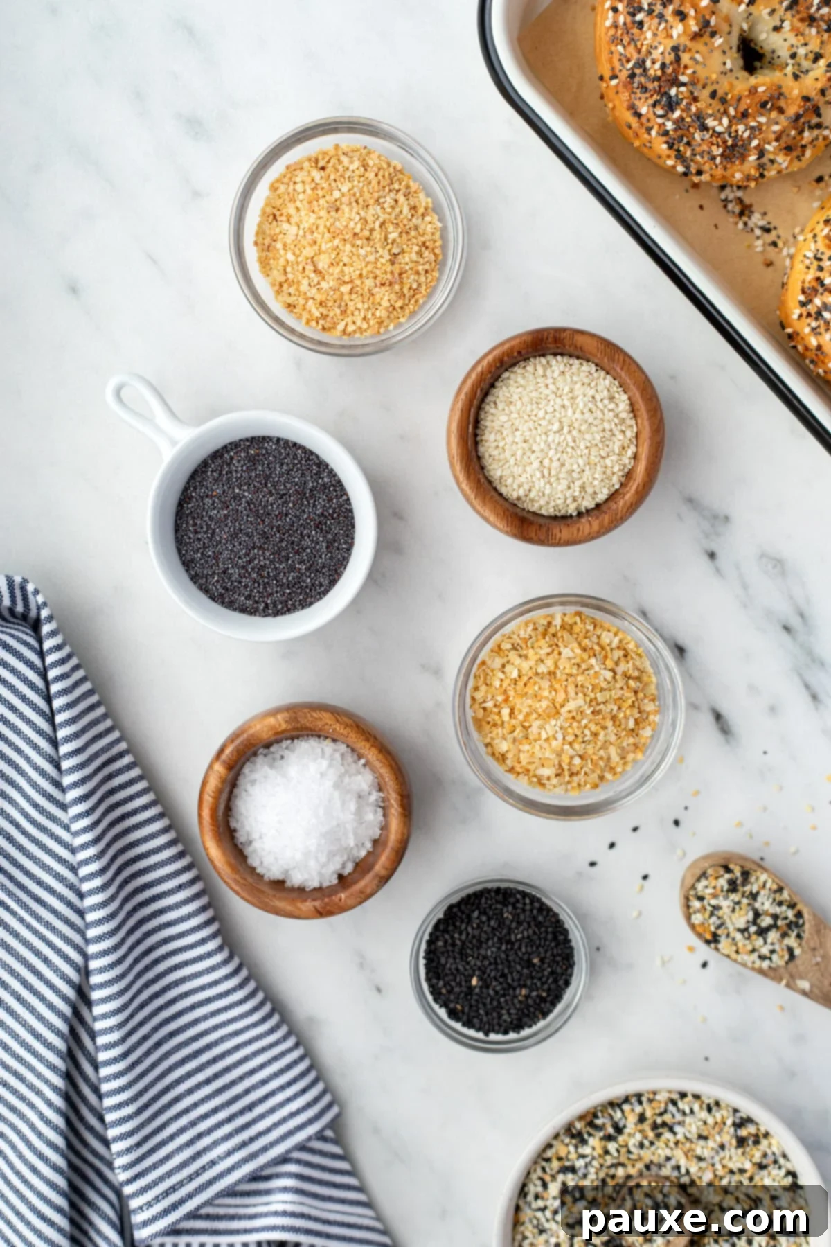 The Ultimate Seed & Spice Blend 3 Small bowls of seasonings needed to make everything bagel seasoning, including poppy seeds, dried minced garlic, etc.