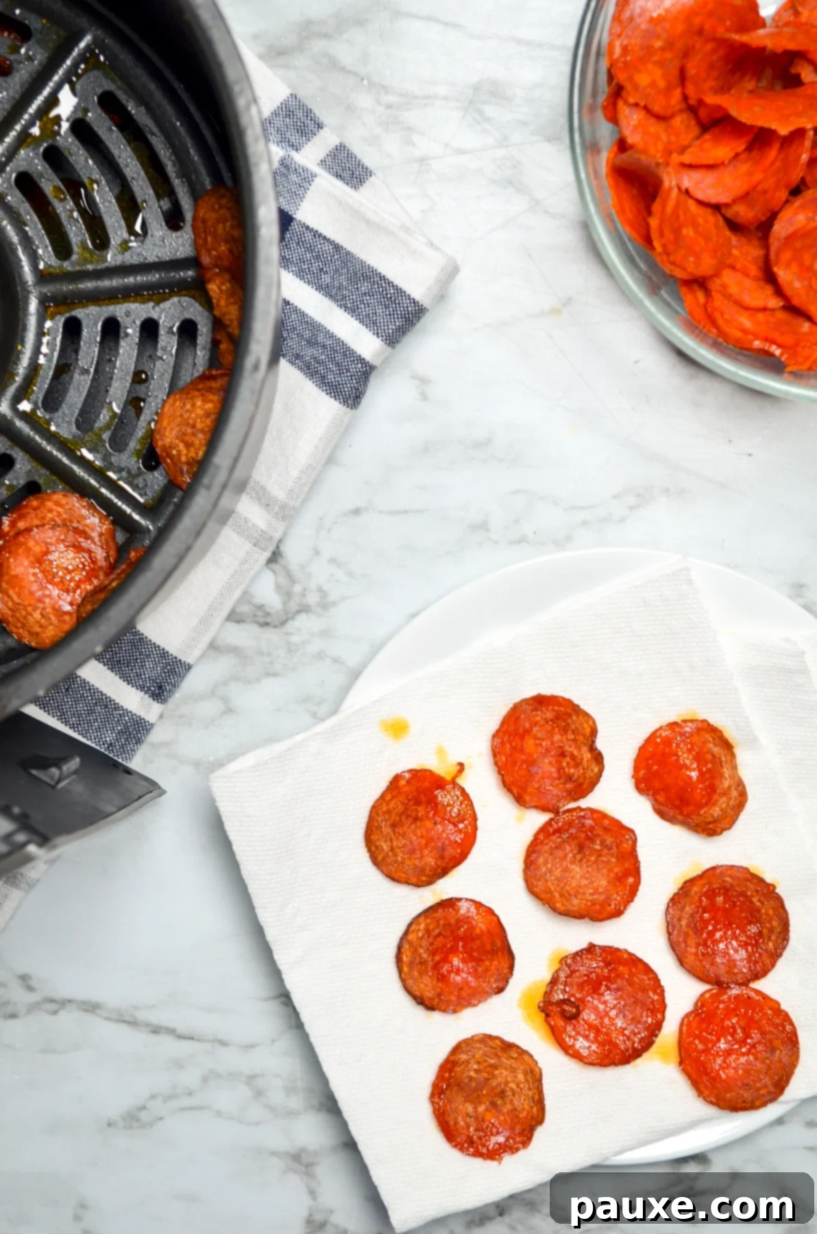Air Fried Crispy Pepperoni 10 Air fryer pepperoni chips draining on paper towel to remove excess grease.