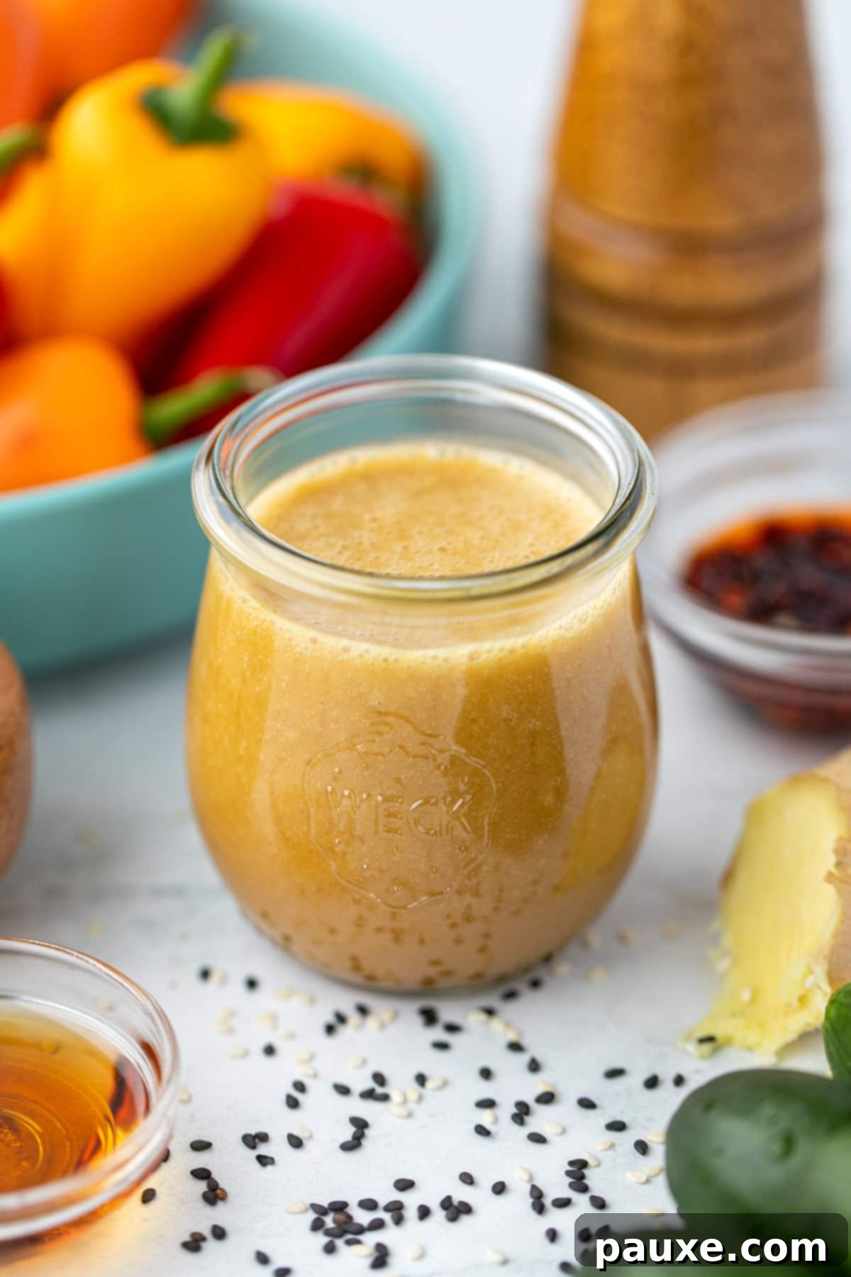 A small jar filled with homemade sesame ginger dressing.
