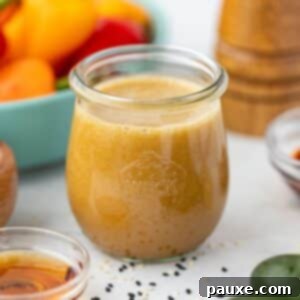 A small jar filled with homemade ginger sesame dressing.
