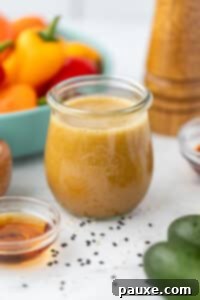 A small jar filled with ginger sesame dressing.