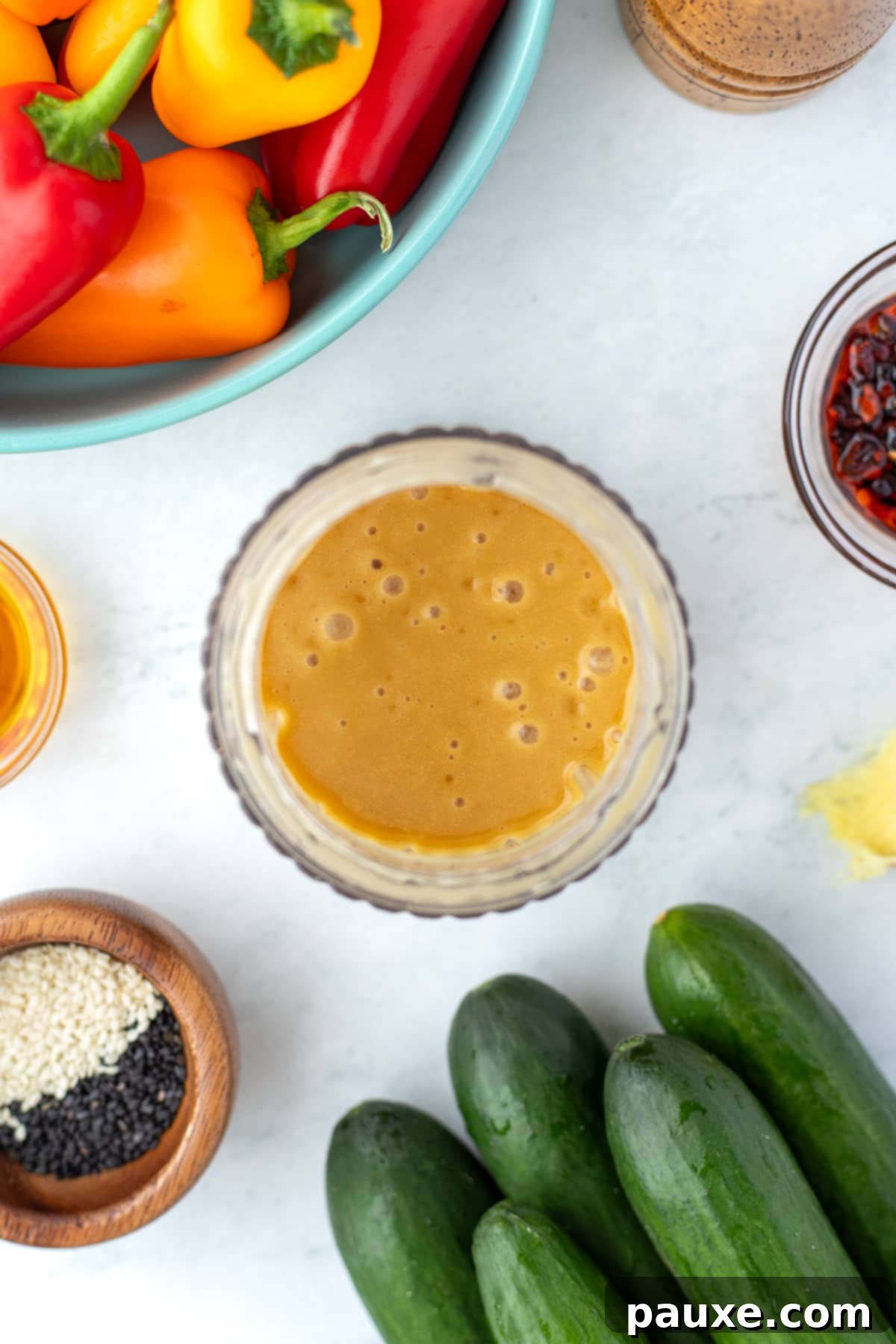 A small blender cup filled with ginger sesame dressing.