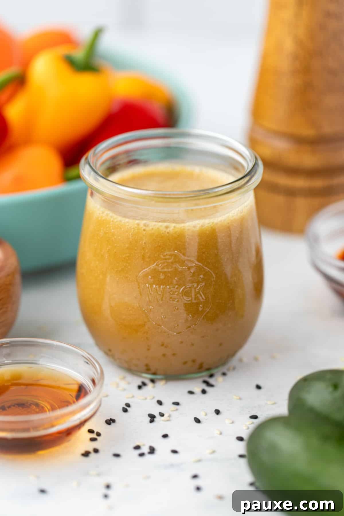 A small jar filled with ginger sesame dressing.