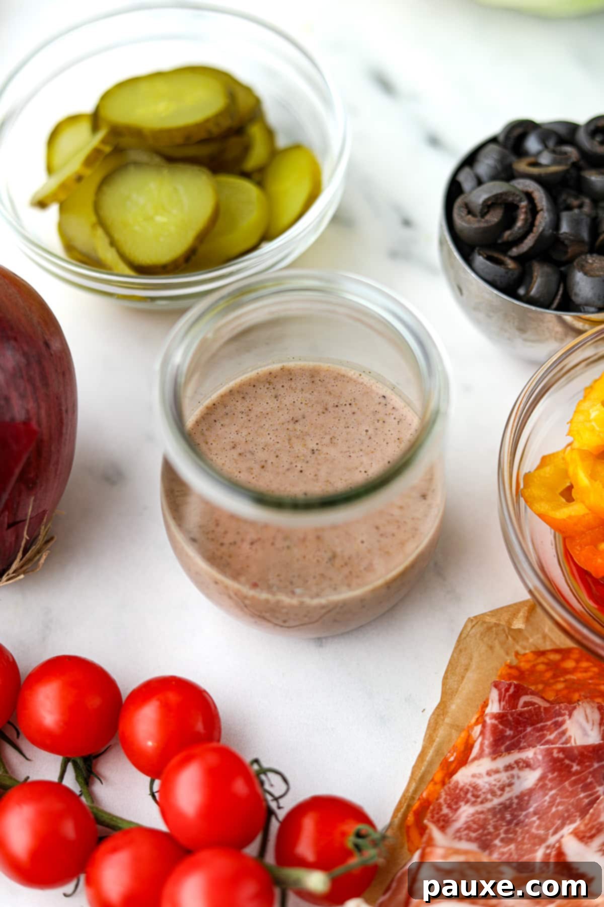 The Sub Secret 2 A small jar of sub sauce, surrounded by sub fillings, ready to be enjoyed.