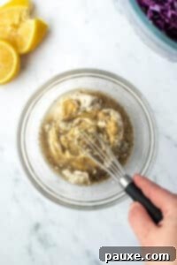 Fresh Israeli Cabbage Slaw 14 Whisking together mayo, lemon juice, dijon, and black pepper to make a dressing.