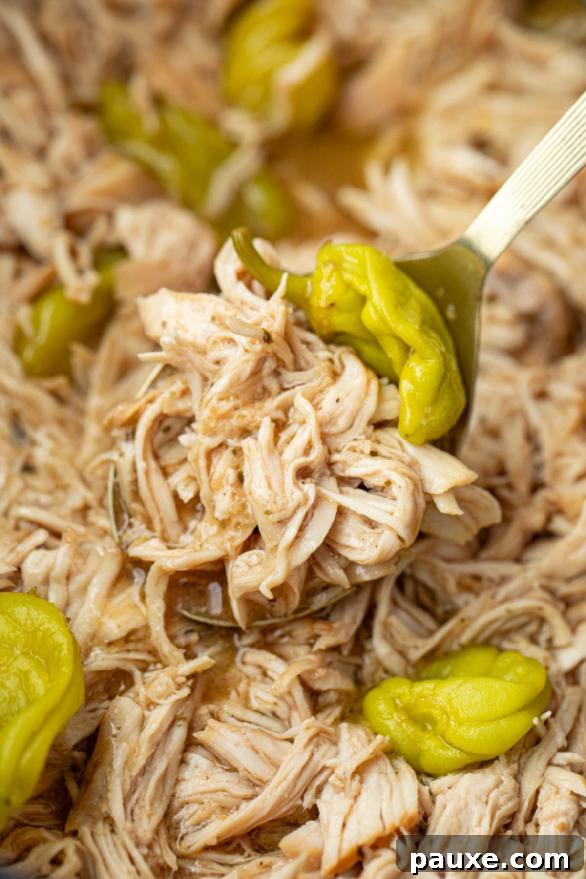Mississippi Pot Roast Chicken 2 Scooping shredded chicken from a large slow cooker, highlighting its tenderness and rich sauce.