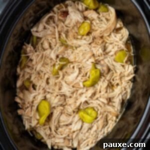 Mississippi Pot Roast Chicken 12 A slow cooker filled with shredded chicken and topped with pepperoncini peppers.