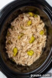 Mississippi Pot Roast Chicken 16 A slow cooker filled with juicy shredded chicken and a few pepperoncini peppers.