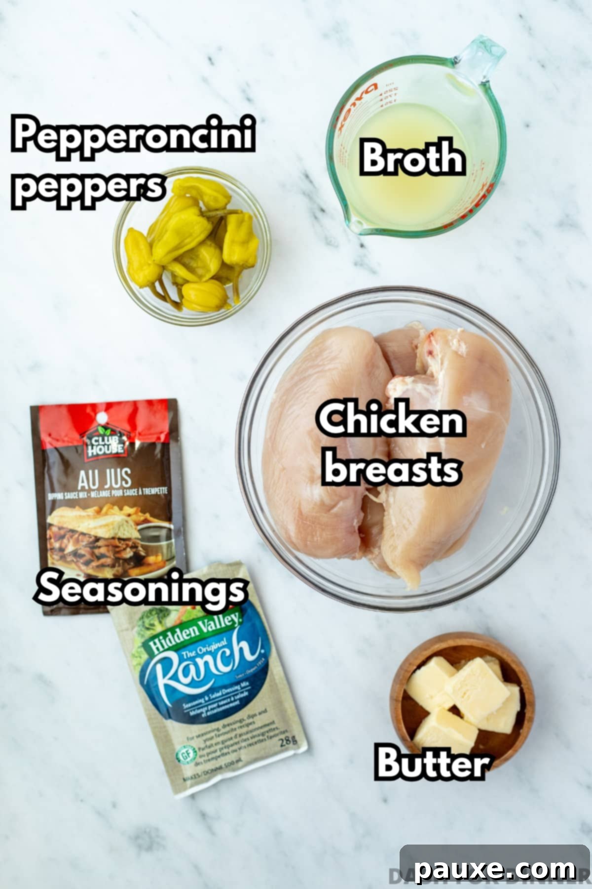 Mississippi Pot Roast Chicken 3 The simple ingredients needed to make Mississippi chicken, including a packet of ranch mix and au jus mix, neatly arranged.