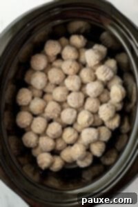 Dixie Glazed Meatballs 11 A slow cooker filled with frozen meatballs.