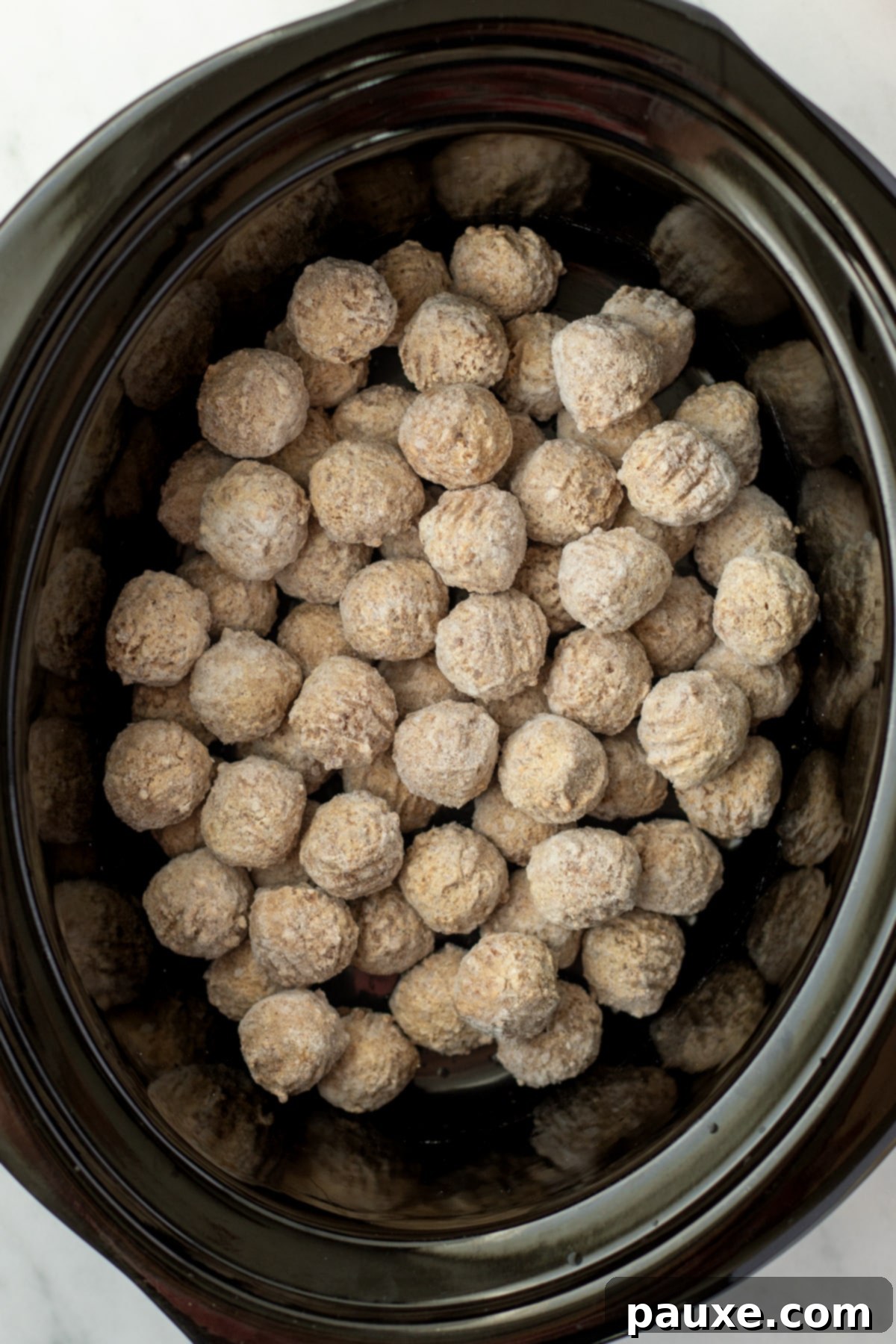 Dixie Glazed Meatballs 4 A slow cooker filled with frozen meatballs.