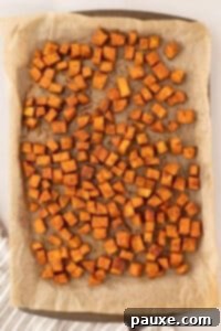 Golden Roasted Sweet Potato Bites 15 A sheet pan filled with perfectly roasted sweet potato cubes, golden brown and slightly crispy, fresh from the oven.