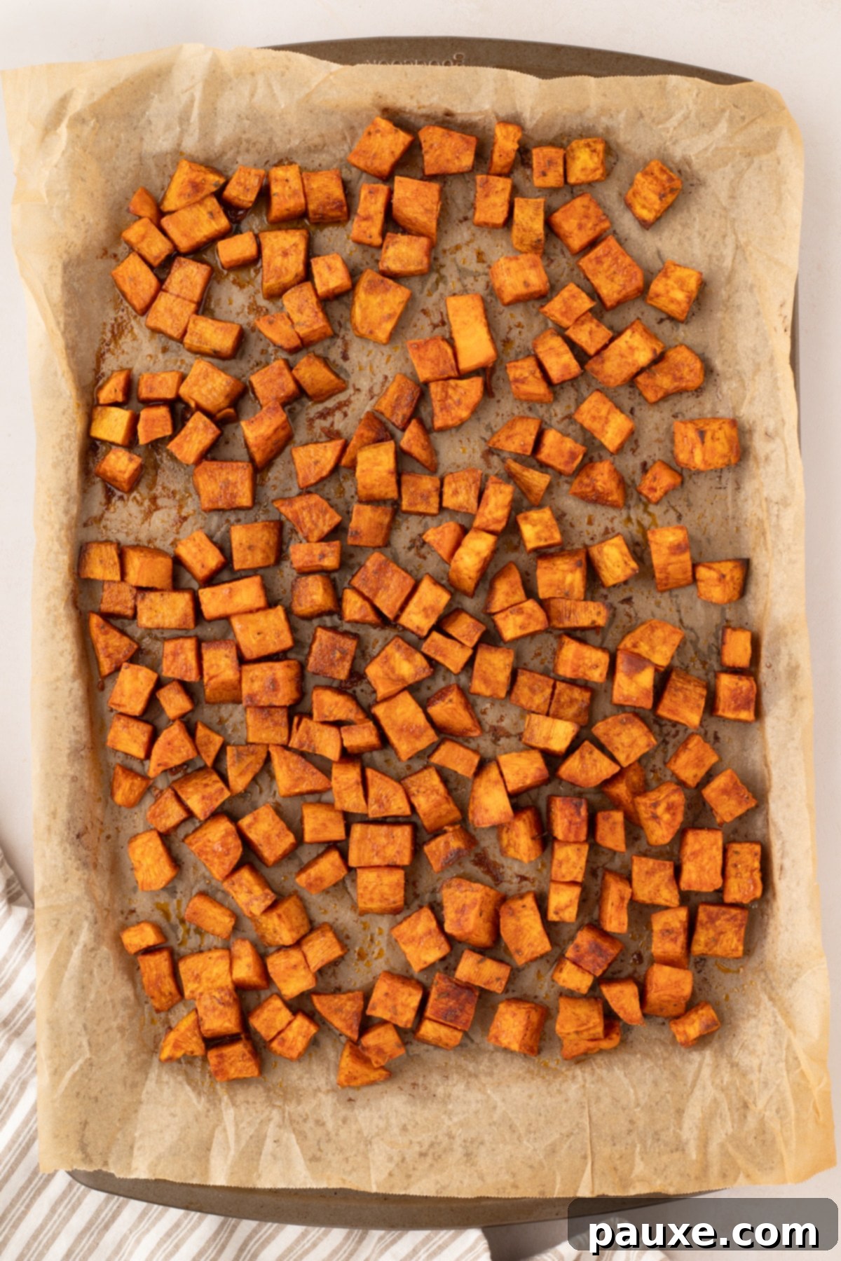 Golden Roasted Sweet Potato Bites 7 A sheet pan filled with perfectly roasted sweet potato cubes, golden brown and slightly crispy.