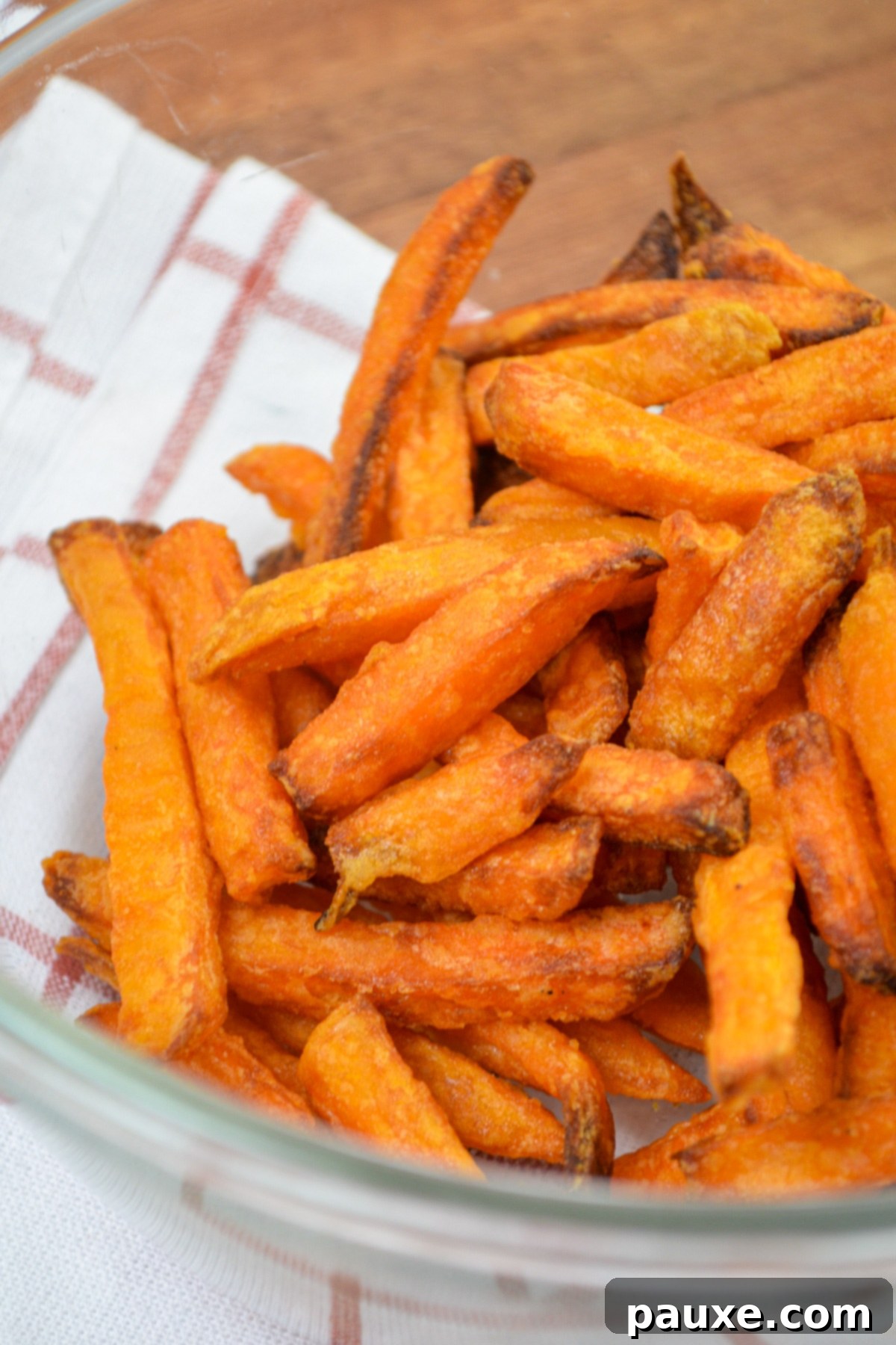 Crispy Air Fryer Sweet Potato Fries 5 A serving bowl filled with golden, crispy air fryer sweet potato fries.