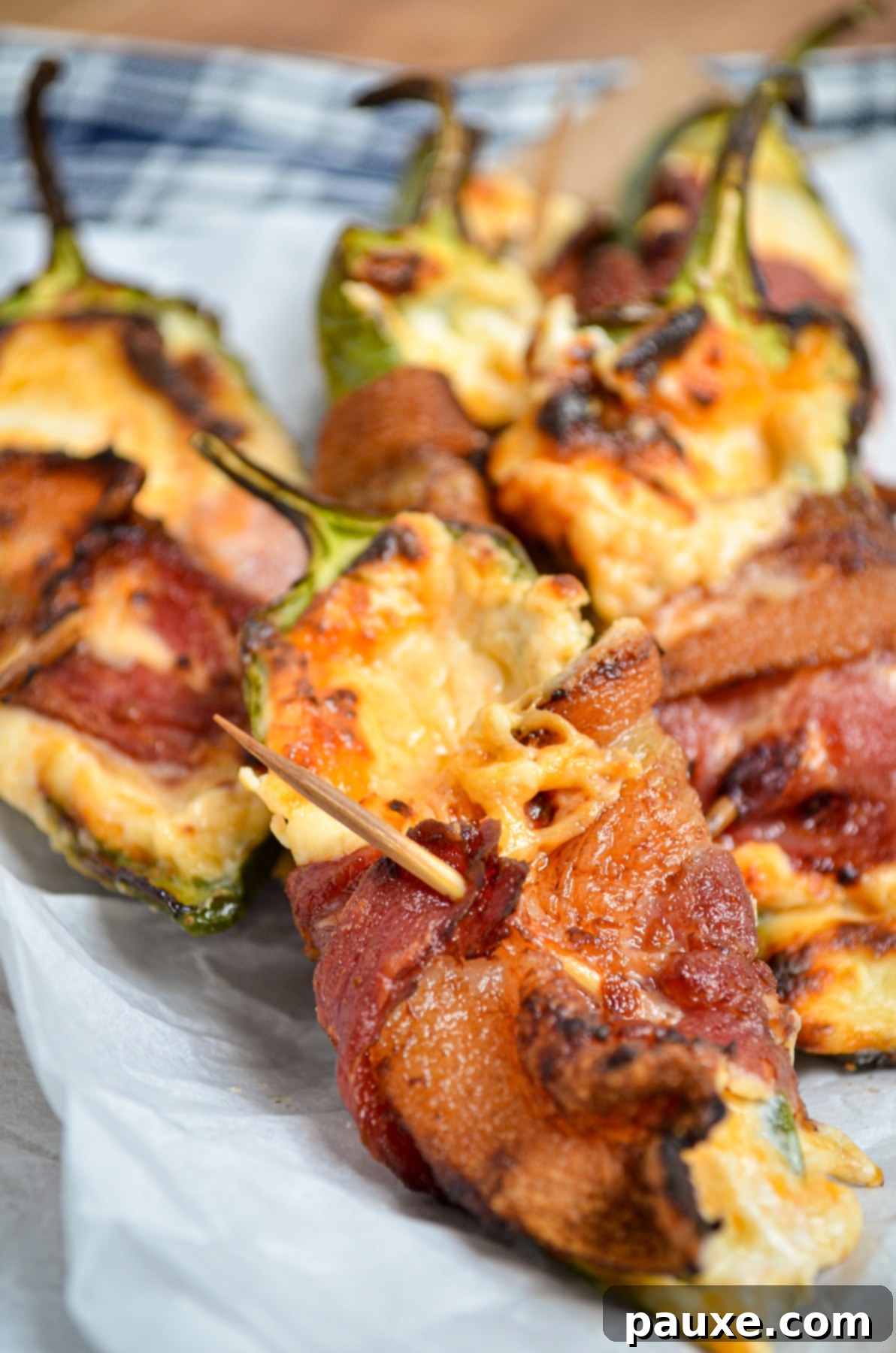 Crispy Air-Fried Jalapeño Poppers 2 A vibrant photo of perfectly cooked Air Fryer Jalapeno Poppers, showcasing their crispy bacon and bubbly cheese filling, ready to be enjoyed.