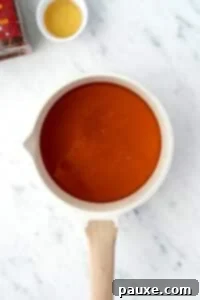 Crafting Homemade Hot Honey 12 A small saucepan with honey inside.