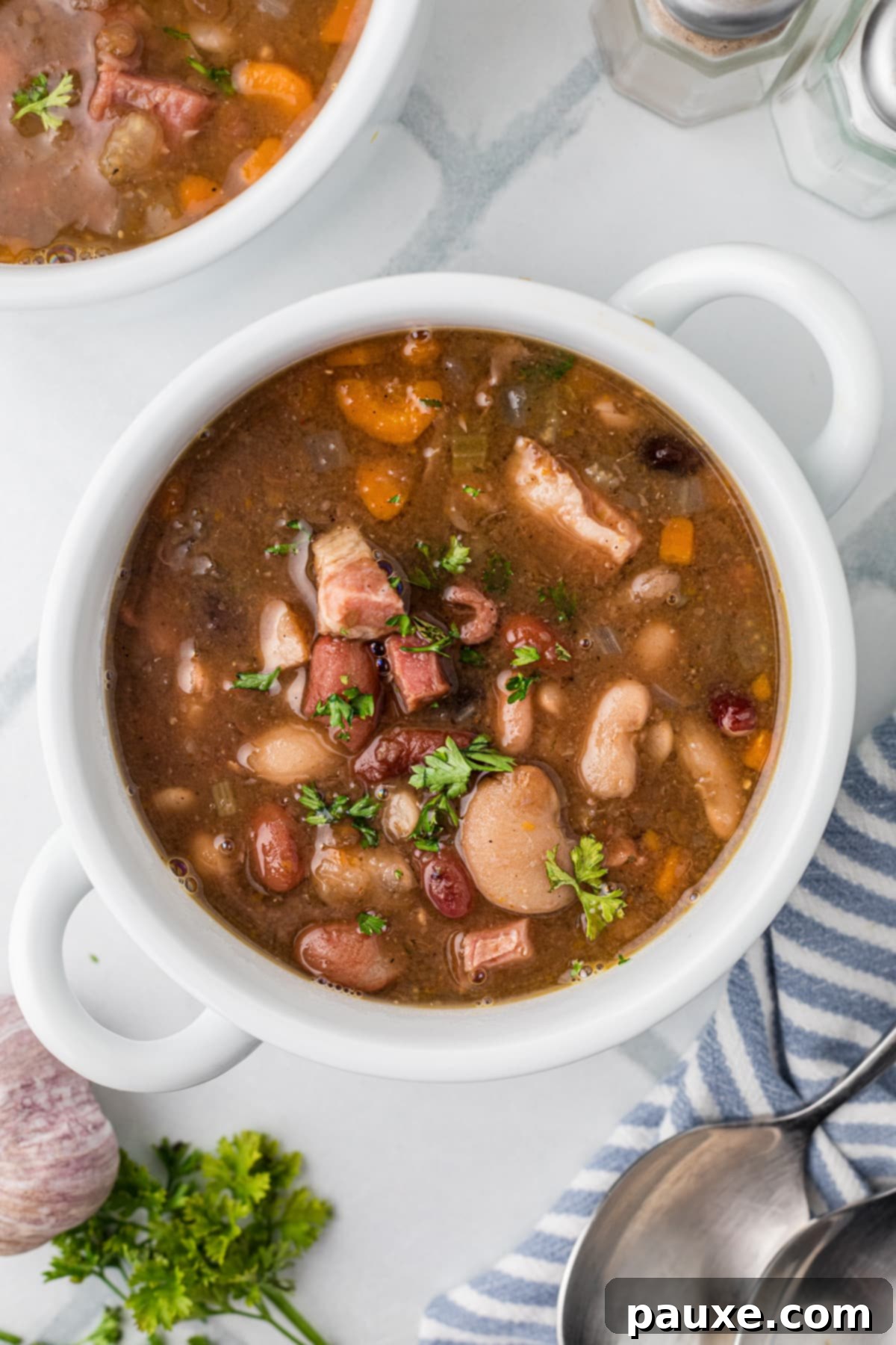Hearty Fifteen-Bean Soup 2 A bowl of bean soup filled with bits of ham, ready to be enjoyed.