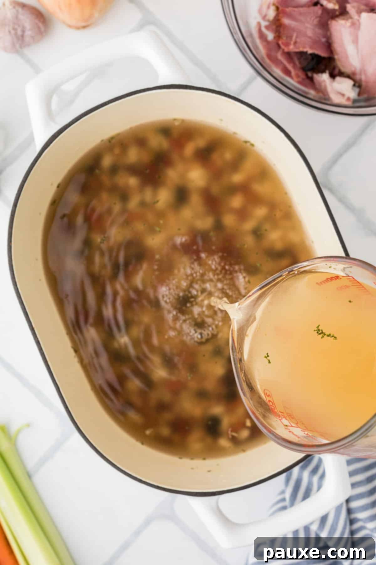 Hearty Fifteen-Bean Soup 4 Pouring chicken broth into a large Dutch oven with dried beans.