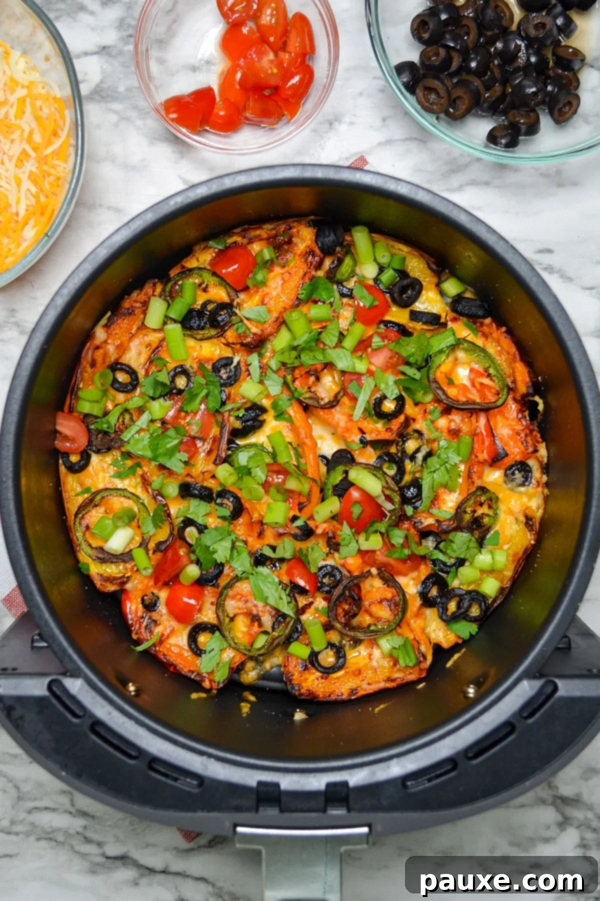 Loaded Air Fryer Mini Bell Pepper Nachos 6 Air fryer basket showing perfectly cooked mini pepper nachos with melted cheese.