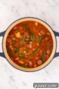 Mossy Potage 18 A large Dutch oven filled with a hearty tomato and broth-based soup.