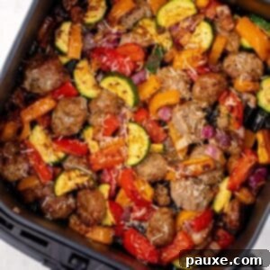 Air-Fried Chicken Sausage & Roasted Veggies 10 Cooked sausage pieces and vegetables in an air fryer basket.