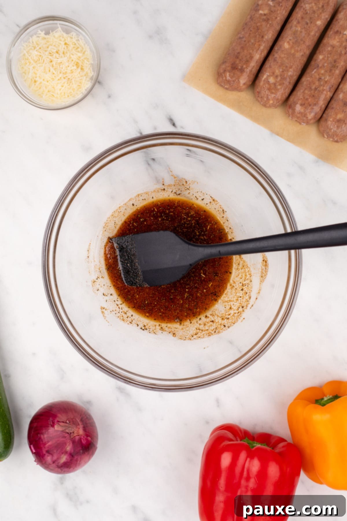 Air-Fried Chicken Sausage & Roasted Veggies 4 A mixing bowl with olive oil and a blend of seasonings ready to be stirred.