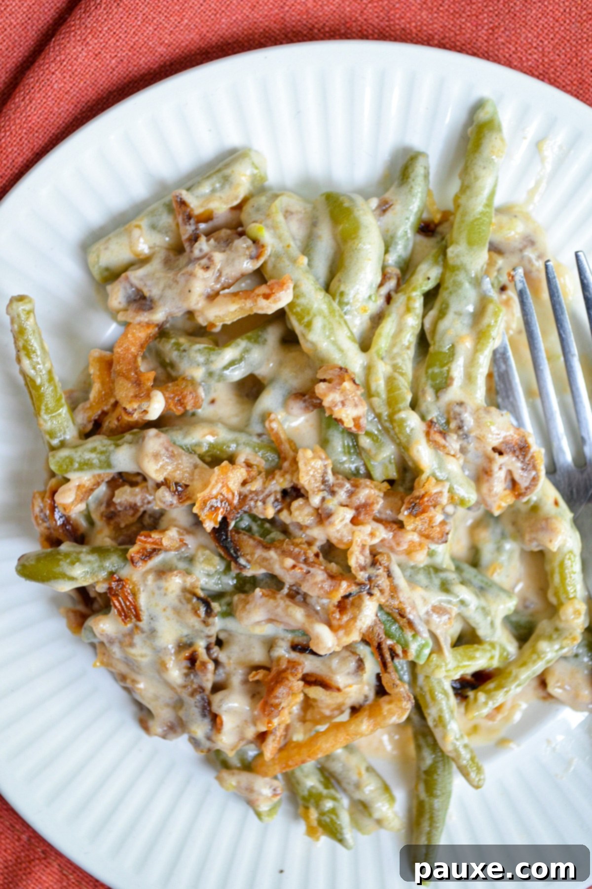 Crockpot Green Bean Comfort 9 A plate of green bean casserole, topped with french fried onions.