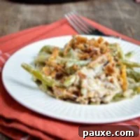 Crockpot Green Bean Comfort 10 A plate of green bean casserole, served on a small plate on top of cloth napkin.