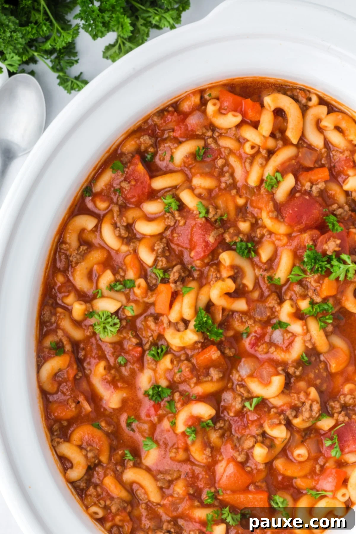 Homestyle Slow Cooker Goulash 2 A slow cooker filled with ground beef and macaroni, ready to be served as a hearty American Goulash.