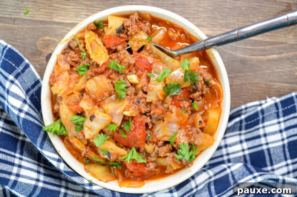 Instant Pot Lazy Cabbage Roll Dinner 7 A bowl of unstuffed cabbage roll soup on a wood background.