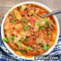Instant Pot Lazy Cabbage Roll Dinner 9 A bowl of cabbage, ground beef, and vegetables, sprinkled with parsley.