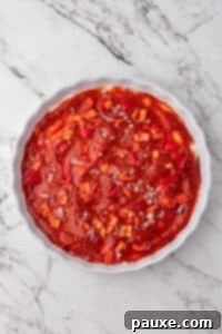 Baked Pepperoni Pizza Dip 14 A baking dish with cream cheese, pizza sauce, and toppings layered.