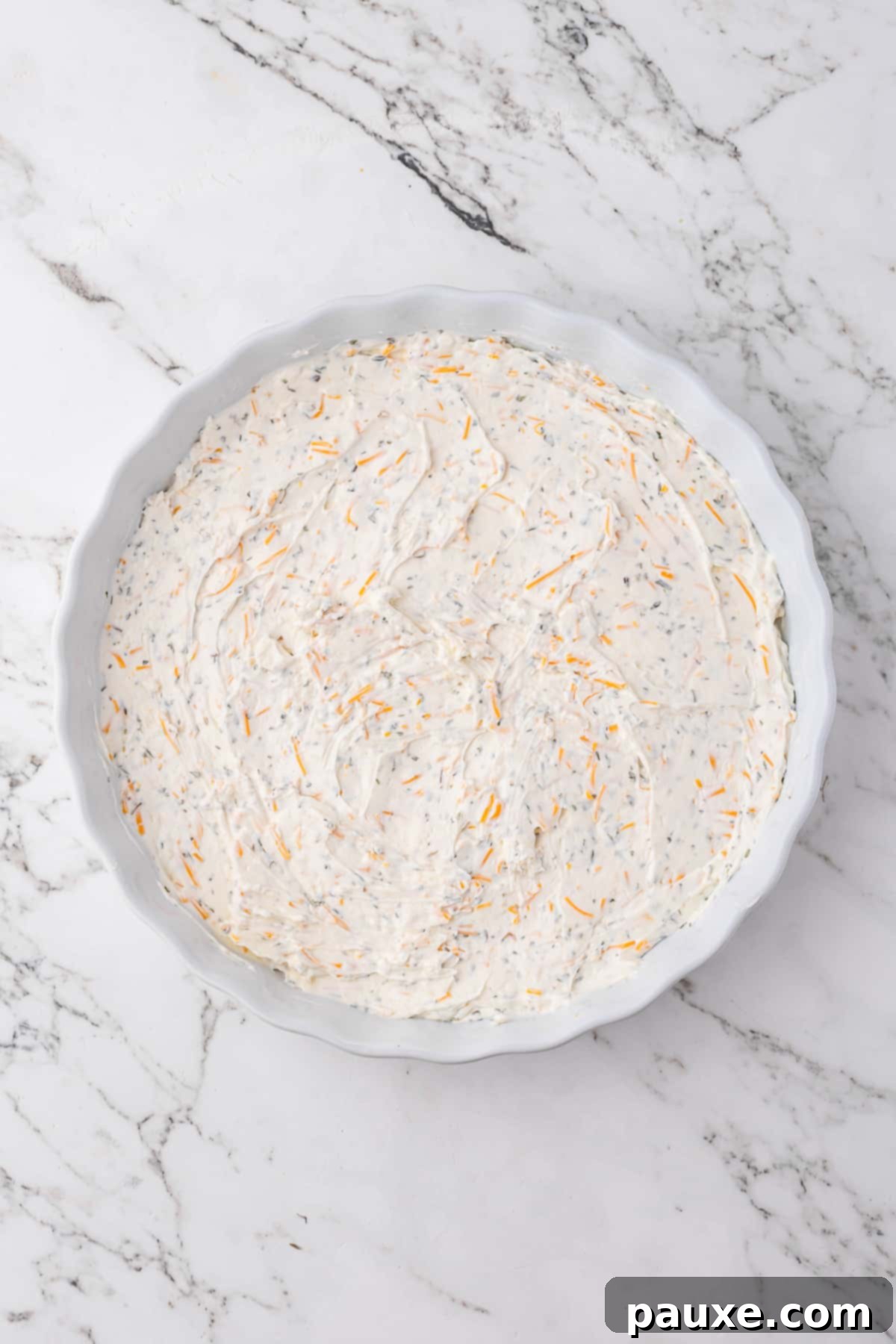 Baked Pepperoni Pizza Dip 5 The creamy, cheesy base mixture spread evenly into the bottom of a round baking dish.