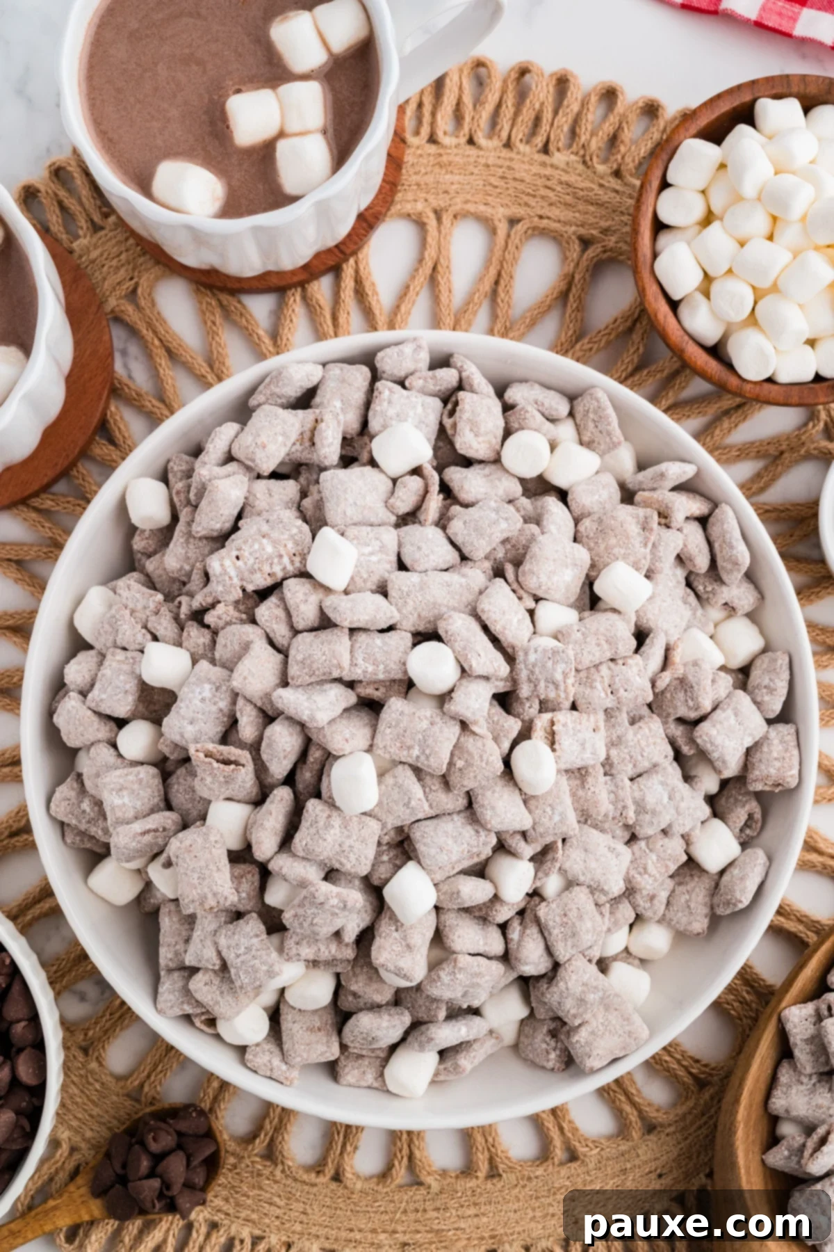 A bowl of muddy buddy chex mix in a bowl with mini marshmallows.