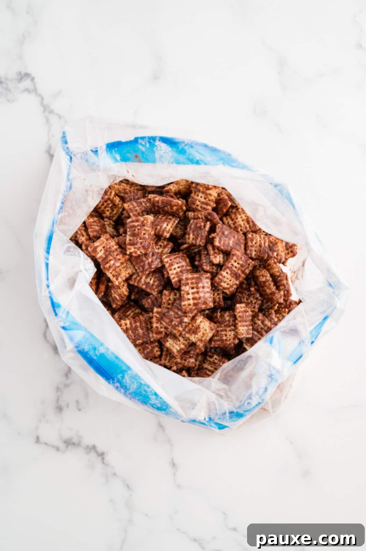 A bag filled with chocolate-coated Chex cereal.
