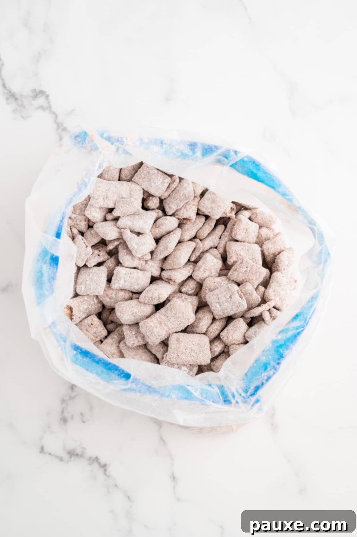A freezer bag filled with Chex cereal coated in powdered sugar.