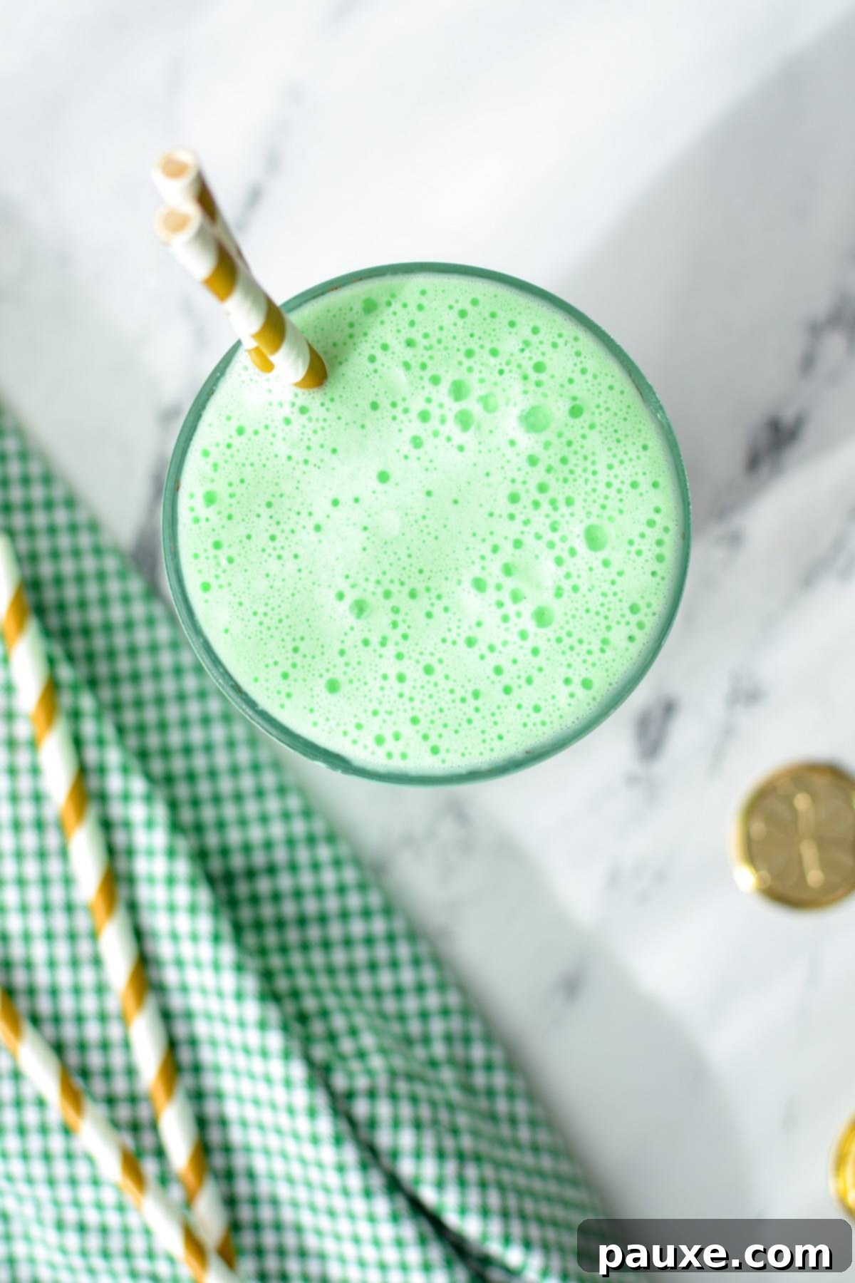 Whip Up Your Own McDonald's Shamrock Shake 7 An overhead shot of a green milkshake with gold striped straws.