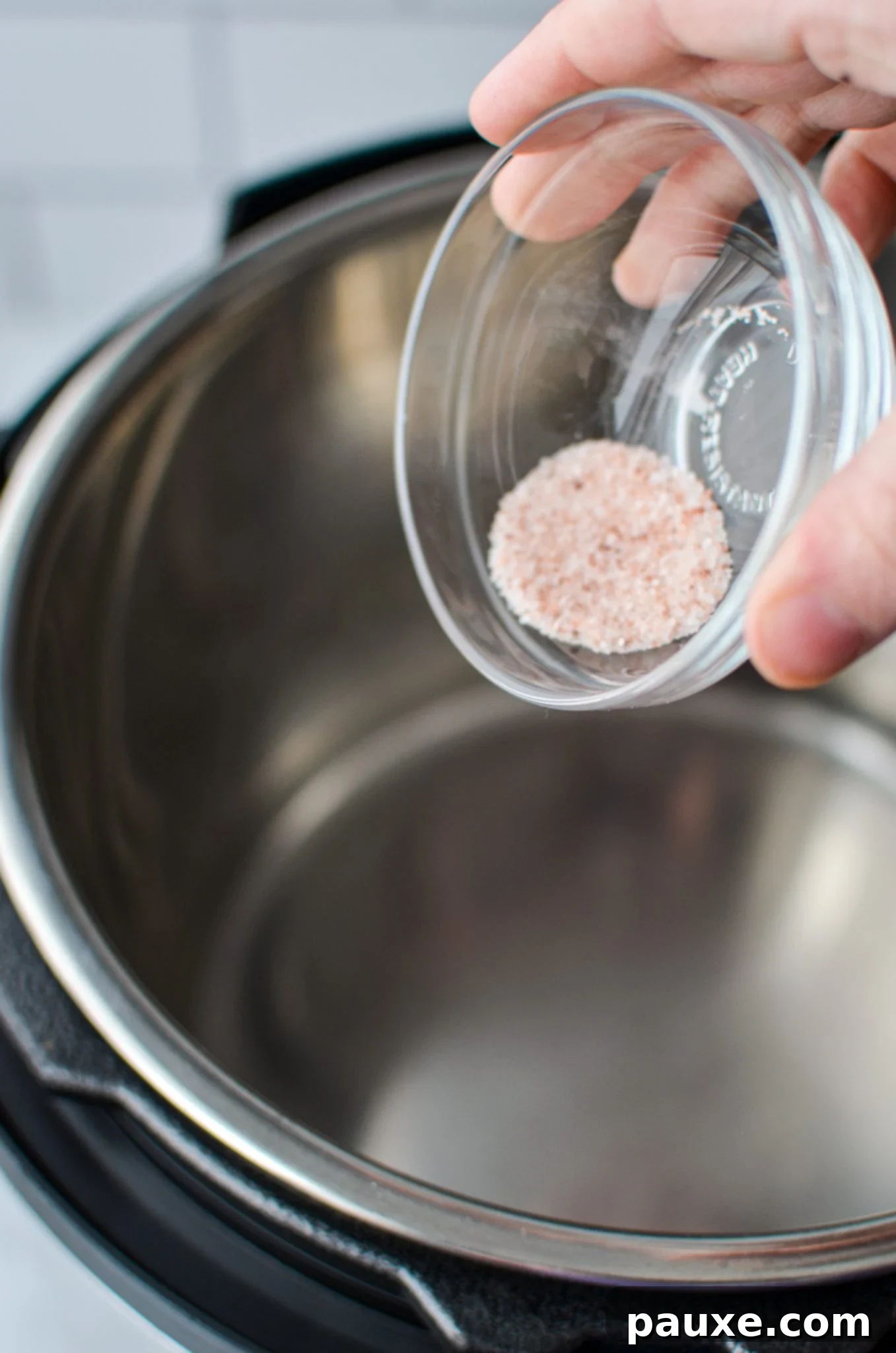 Perfect Instant Pot Frozen Broccoli 5 Adding salt to the insert of an Instant Pot before adding water and broccoli.