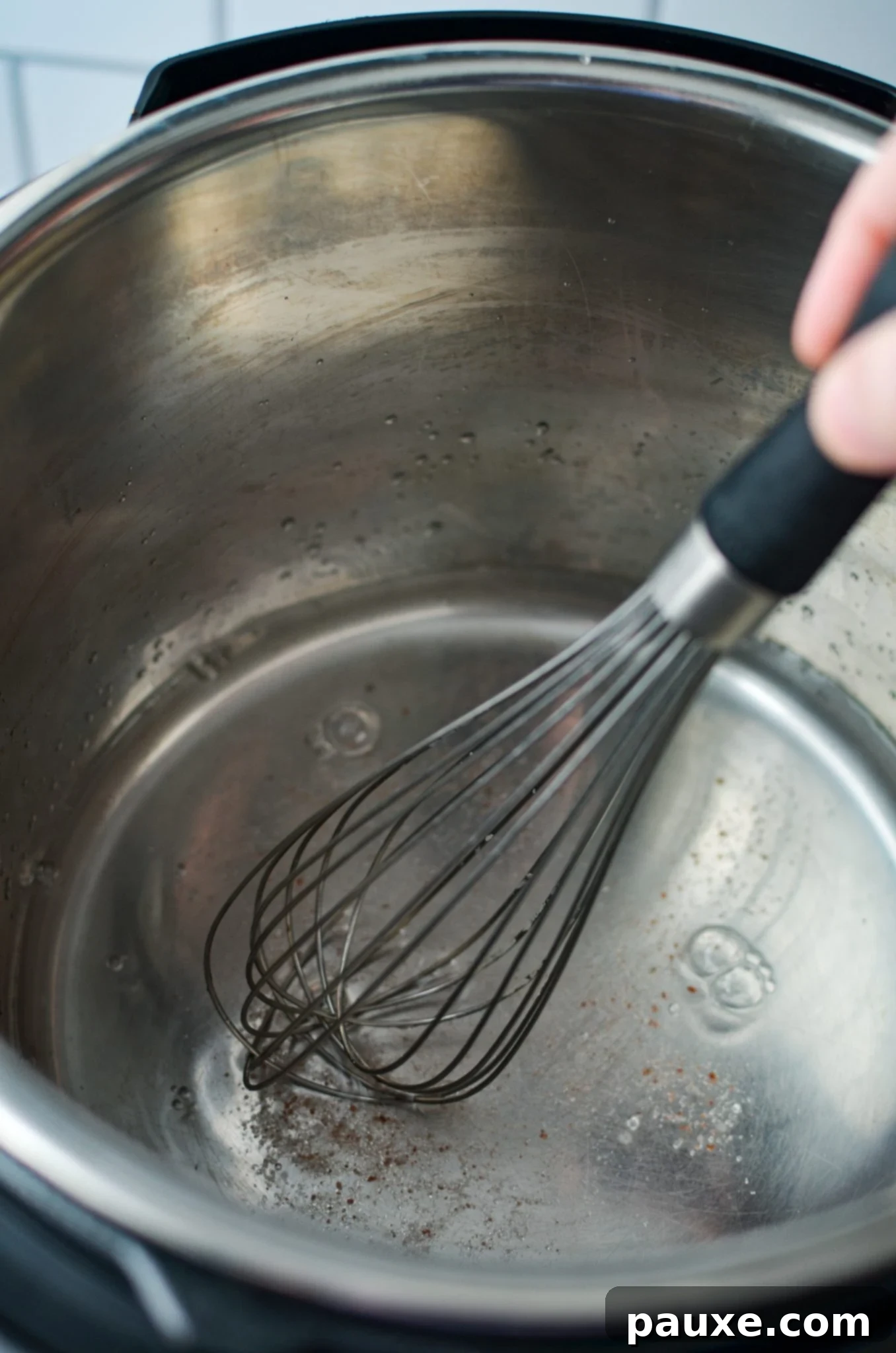 Perfect Instant Pot Frozen Broccoli 6 Whisking salt into water in an Instant Pot to dissolve before steaming.