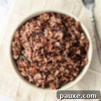 Perfect Instant Pot Wild Rice Medley 9 An overhead view of a bowl of Instant Pot Wild Rice Blend with a fork.