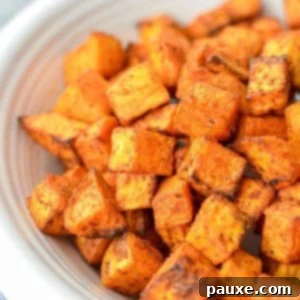 Crispy Air Fryer Sweet Potato Cubes 11 A close up of sweet potato cubes that have been roasted.