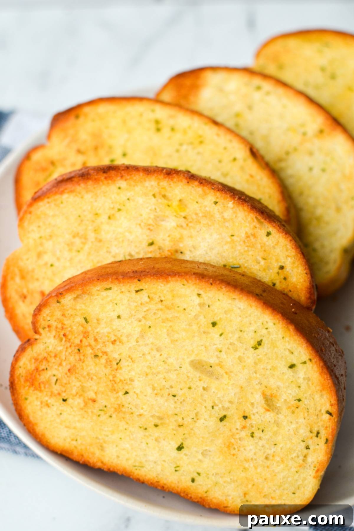 Crispy Air Fryer Texas Garlic Toast 10 A plate of perfectly toasted frozen garlic bread, with 5 golden-brown slices arranged appealingly.
